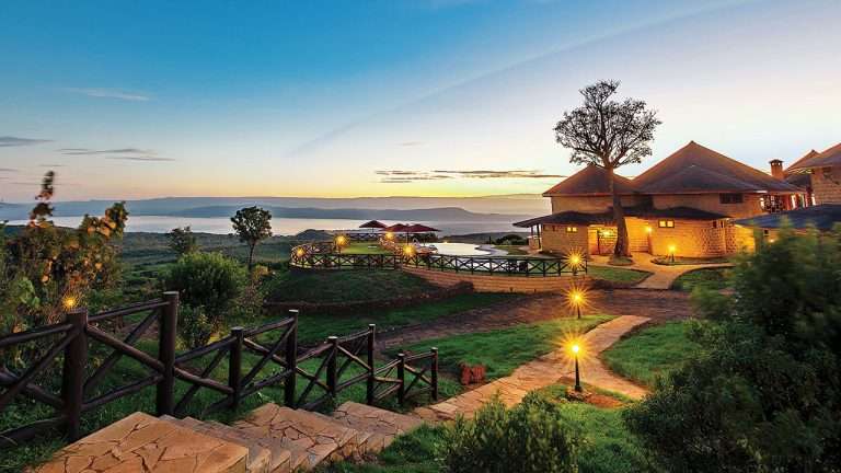 Exterior view of Lake Nakuru Sopa Lodge, a stone-and-thatch lodge set among trees near Lake Nakuru National Park