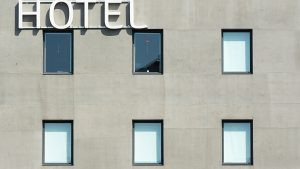 Contemporary hotel facade with minimalist design and geometric windows in a city setting