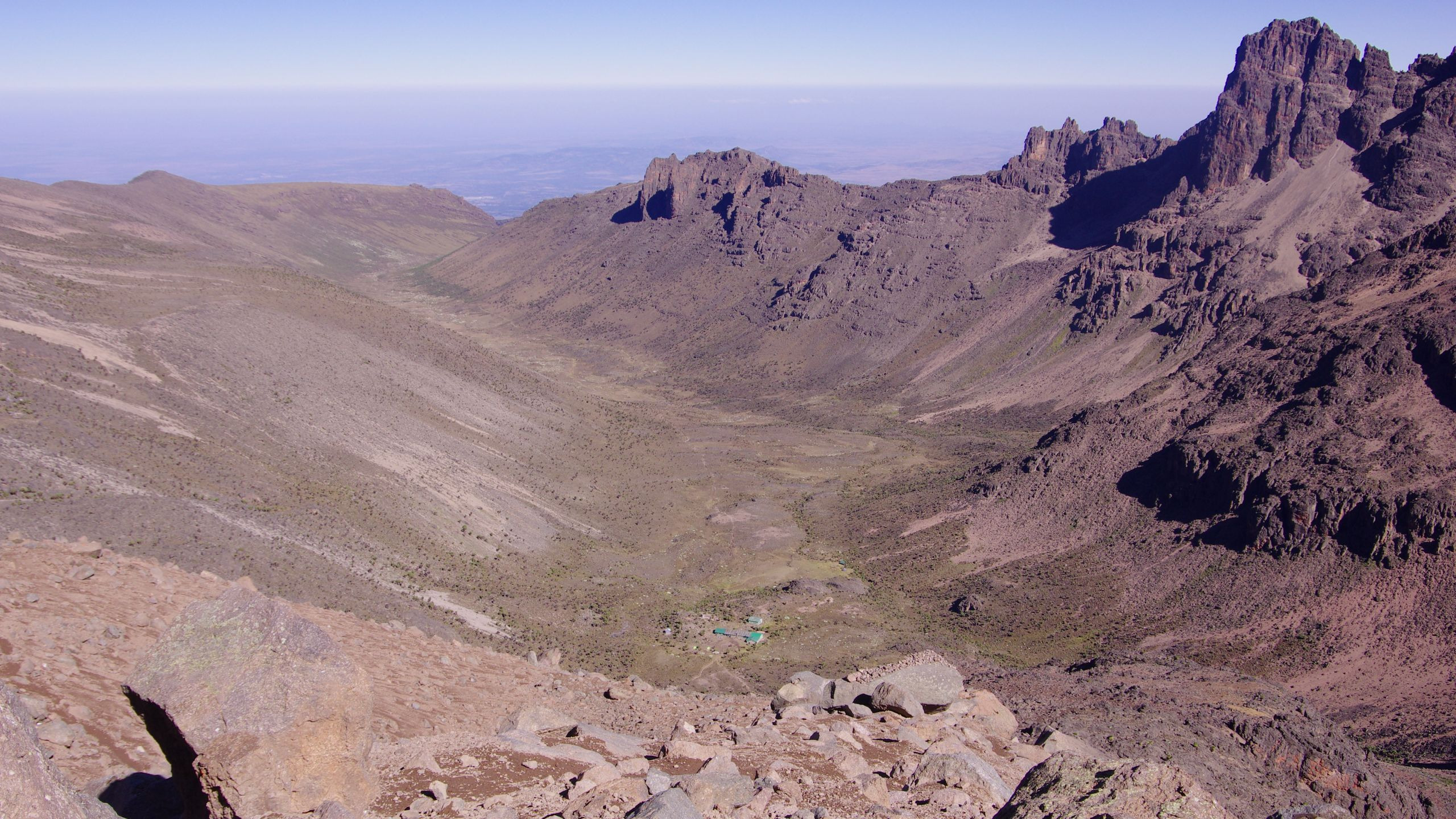 Aerial view of Mount Kenya's jagged rocky peaks and surrounding highland landscape in Kirinyaga County