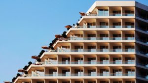Resort hotel building exterior with balconies overlooking manicured grounds