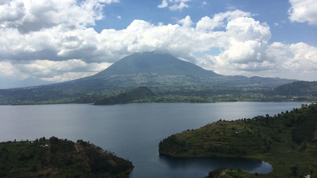 Cloud-wrapped volcanic mountains rising above a lake in the Virunga highlands near Volcanoes National Park, Rwanda