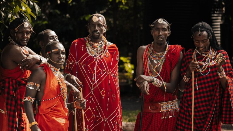Maasai dancers in traditional beaded attire perform a cultural dance for an audience in Nairobi, Kenya.