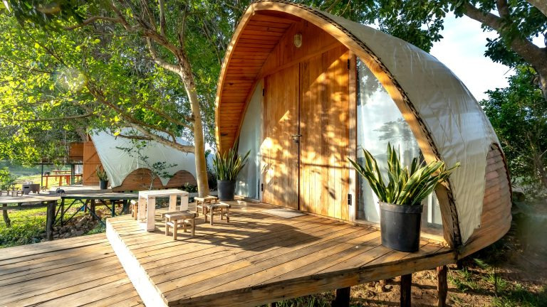 Charming wooden lodge cabin with a deck, nestled among trees