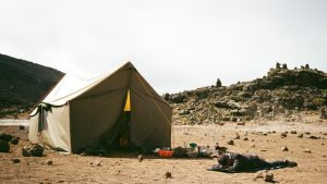 Luxury safari tent set on open ground beneath Mount Kilimanjaro
