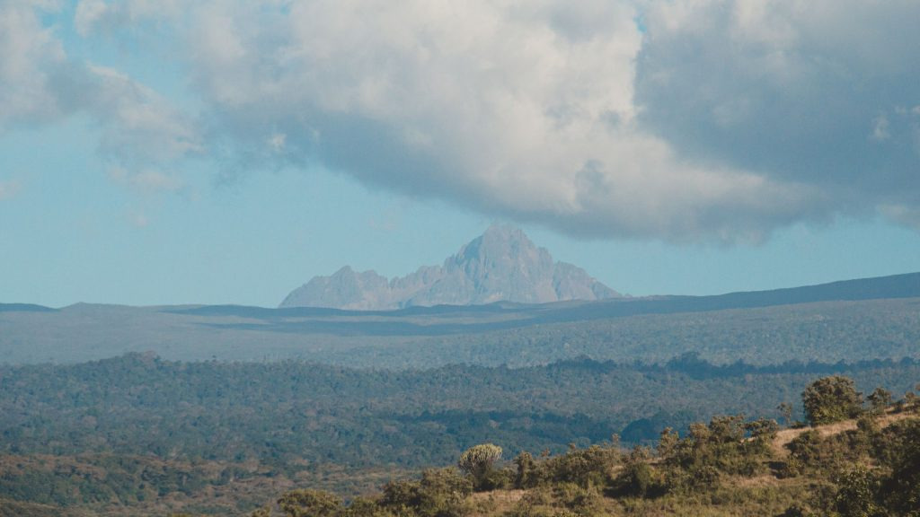 Dramatic rocky mountain peak rising into a cloudy sky in the Kenyan highlands