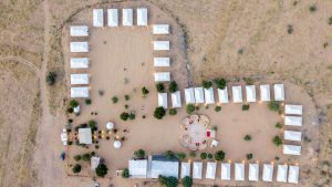 Aerial view of a tented desert camp at dusk