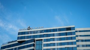 Modern multi-storey hotel building exterior against a clear blue sky